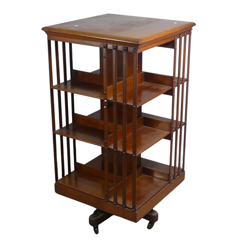 572 - A large Edwardian mahogany revolving Bookcase, square top above three large sectional shelves, raise... 