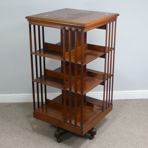 572 - A large Edwardian mahogany revolving Bookcase, square top above three large sectional shelves, raise... 