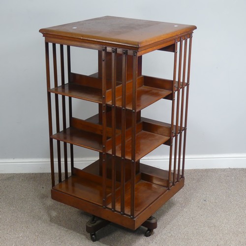 572 - A large Edwardian mahogany revolving Bookcase, square top above three large sectional shelves, raise... 