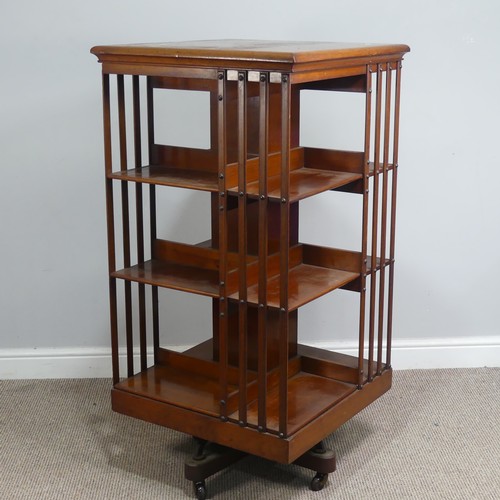 572 - A large Edwardian mahogany revolving Bookcase, square top above three large sectional shelves, raise... 