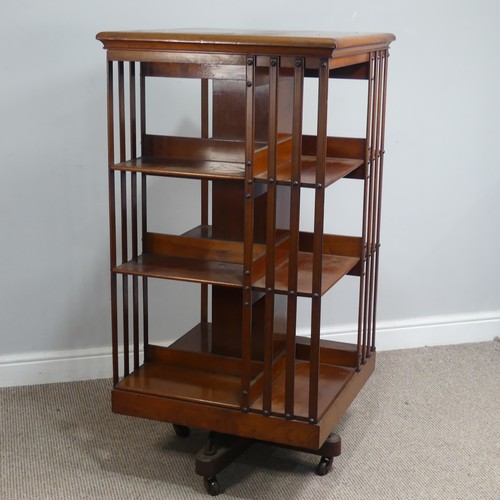 572 - A large Edwardian mahogany revolving Bookcase, square top above three large sectional shelves, raise... 