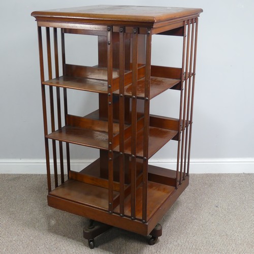 572 - A large Edwardian mahogany revolving Bookcase, square top above three large sectional shelves, raise... 