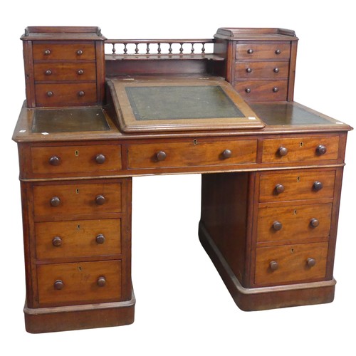 571 - A Victorian oak 'Dickens' pedestal Desk, central top shelf with spindle gallery flanked by wellingto... 