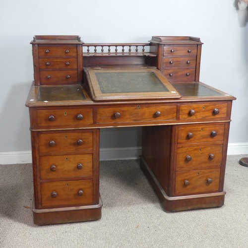 571 - A Victorian oak 'Dickens' pedestal Desk, central top shelf with spindle gallery flanked by wellingto... 