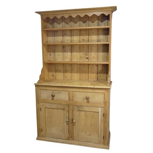 640 - An early 20th century pine Dresser, moulded cornice above three shelves, raised on base with two sho... 