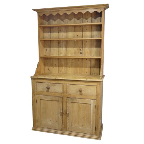 640 - An early 20th century pine Dresser, moulded cornice above three shelves, raised on base with two sho... 