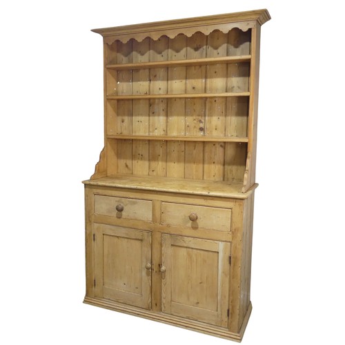 640 - An early 20th century pine Dresser, moulded cornice above three shelves, raised on base with two sho... 