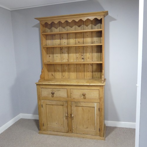 640 - An early 20th century pine Dresser, moulded cornice above three shelves, raised on base with two sho... 