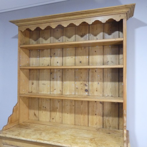 640 - An early 20th century pine Dresser, moulded cornice above three shelves, raised on base with two sho... 