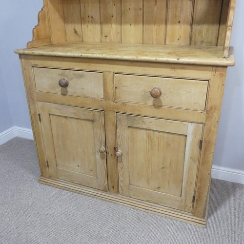 640 - An early 20th century pine Dresser, moulded cornice above three shelves, raised on base with two sho... 