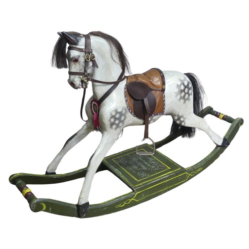 666 - A good early 20th century carved and painted rocking Horse, with saddle, hair, and glass eyes, quote... 