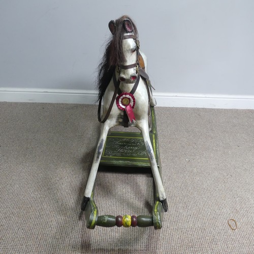 666 - A good early 20th century carved and painted rocking Horse, with saddle, hair, and glass eyes, quote... 