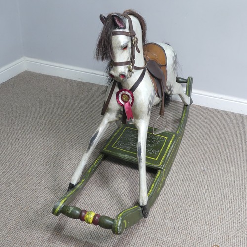 666 - A good early 20th century carved and painted rocking Horse, with saddle, hair, and glass eyes, quote... 