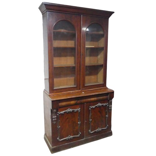 678 - A Victorian mahogany glazed Bookcase, moulded cornice over arched glazed doors, raised on cupboard b... 