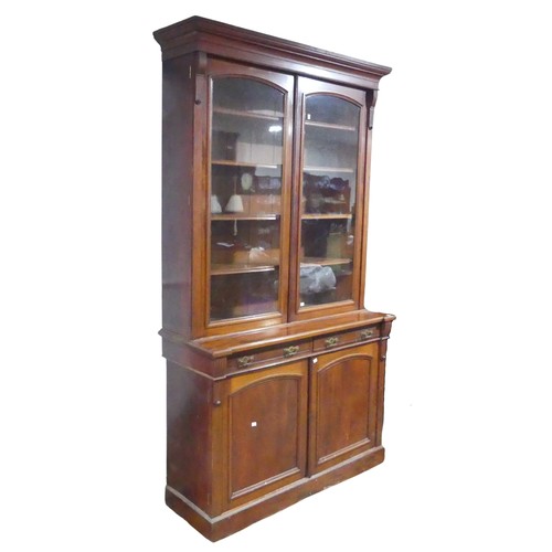 680 - An antique mahogany glazed Bookcase, moulded cornice over large glazed doors, raised on base with tw... 