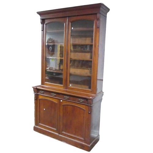 680 - An antique mahogany glazed Bookcase, moulded cornice over large glazed doors, raised on base with tw... 