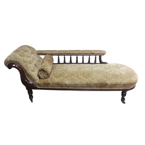 647 - A Victorian mahogany chaise Longue, with turned spindle gallery back, raised on turned supports and ... 