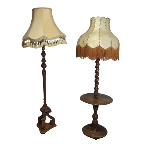 713 - An early 20th century mahogany standard Lamp, with reeded and foliate carved column raised on tripod... 