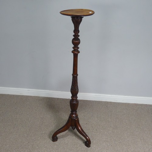 650 - A Victorian mahogany Torchere / plant Stand, circular top raised on turned and foliate carved column... 