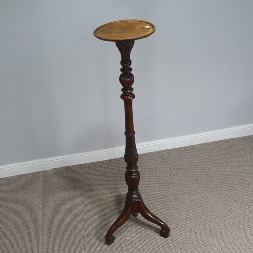 650 - A Victorian mahogany Torchere / plant Stand, circular top raised on turned and foliate carved column... 