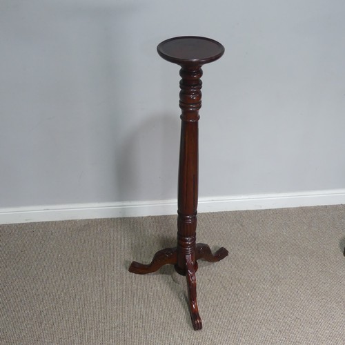 665 - A mahogany Torchere / Plant Stand, circular top raised on carved and reeded column and tripod base, ... 