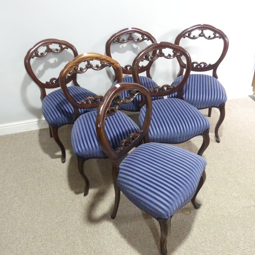 653 - A set of six mahogany balloon-back dining Chairs, with carved and pierced back-rests above upholster... 