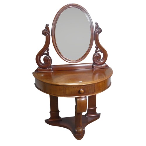 685 - A Victorian mahogany demilune dressing Table, bevelled oval mirror flanked by carved scroll supports... 