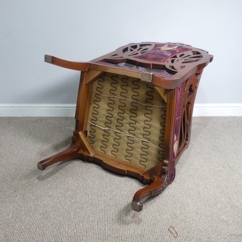 714 - An Art Nouveau style carved mahogany upholstered Armchair, back rest with scrolled and pierced styli... 