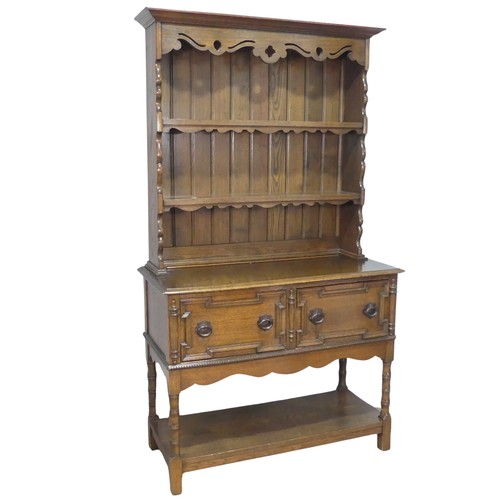 610 - A Carolean style oak Dresser, moulded cornice over pierced frieze and two shelves, above two moulded... 