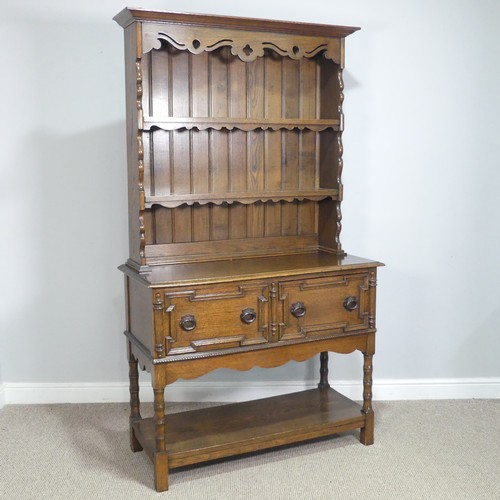 610 - A Carolean style oak Dresser, moulded cornice over pierced frieze and two shelves, above two moulded... 