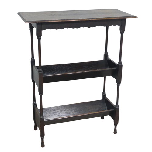 616 - An antique oak magazine Stand / book Trough, moulded rectangular top over shaped frieze, above two t... 