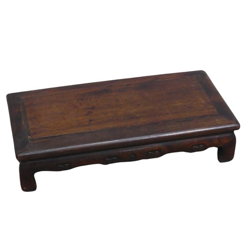 132 - A Chinese carved hardwood opium / coffee Table, top set with rectangular panel, above scrolled and p... 