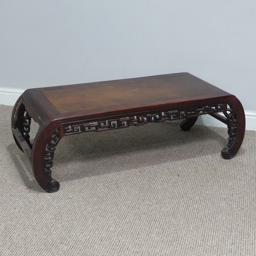 132 - A Chinese carved hardwood opium / coffee Table, top set with rectangular panel, above scrolled and p... 