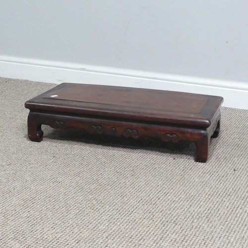 132 - A Chinese carved hardwood opium / coffee Table, top set with rectangular panel, above scrolled and p... 