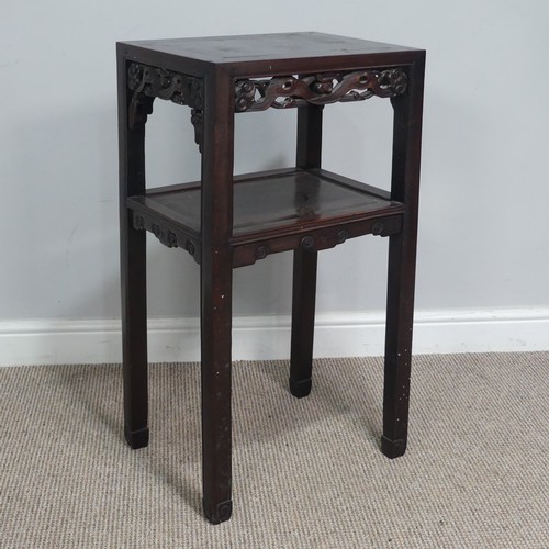 134 - An antique Chinese carved hardwood two tier Table / Plant Stand, rectangular top above carved and pi... 