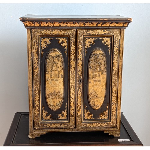 125 - A 19th century hand painted gilt and black lacquer chinoiserie jewellery Cabinet, of small proportio... 