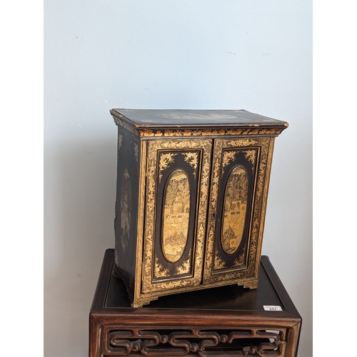 125 - A 19th century hand painted gilt and black lacquer chinoiserie jewellery Cabinet, of small proportio... 