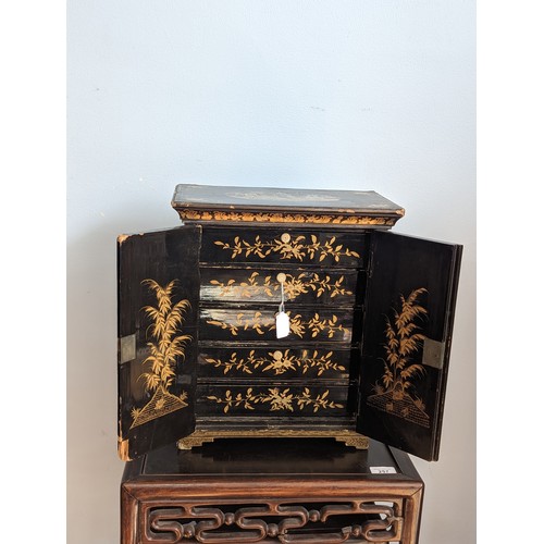 125 - A 19th century hand painted gilt and black lacquer chinoiserie jewellery Cabinet, of small proportio... 