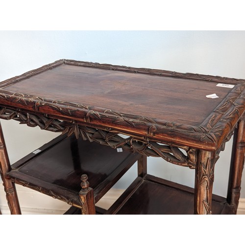 142 - An antique Chinese rosewood side Table, the rectangular top with carved bamboo style edges, tiered a... 