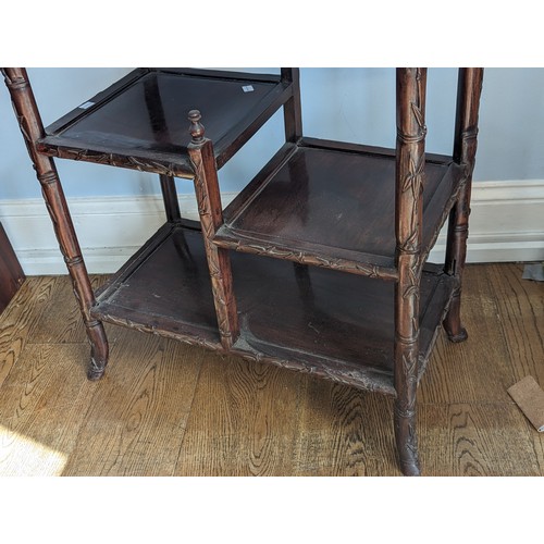 142 - An antique Chinese rosewood side Table, the rectangular top with carved bamboo style edges, tiered a... 