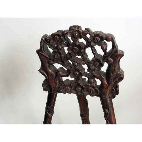 144 - An antique Chinese hardwood artists Easel, with carved and pierced foliate pediment raised on three ... 