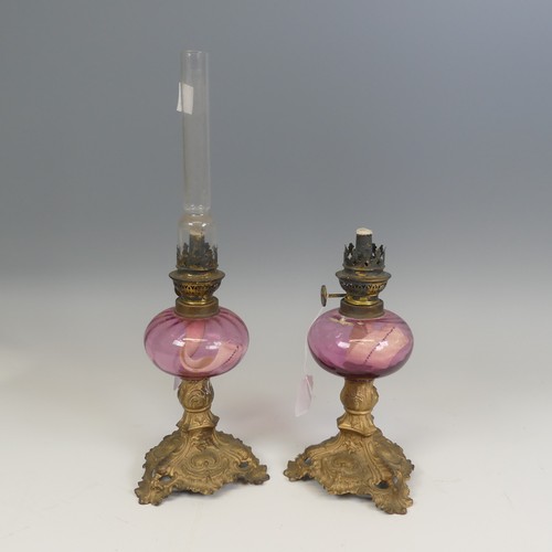 532 - A pair of French late 19th century Oil Lamps, made by 'Gaudard', cranberry glass reservoirs raised o... 