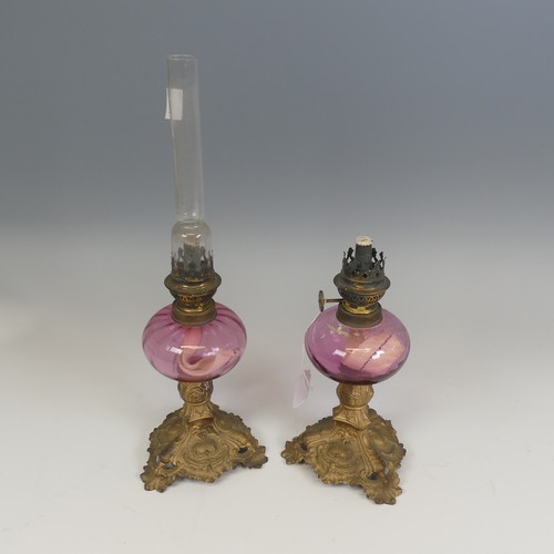 532 - A pair of French late 19th century Oil Lamps, made by 'Gaudard', cranberry glass reservoirs raised o... 