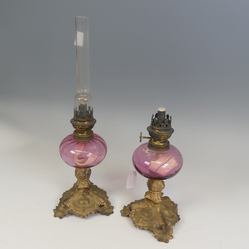 532 - A pair of French late 19th century Oil Lamps, made by 'Gaudard', cranberry glass reservoirs raised o... 