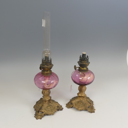 532 - A pair of French late 19th century Oil Lamps, made by 'Gaudard', cranberry glass reservoirs raised o... 