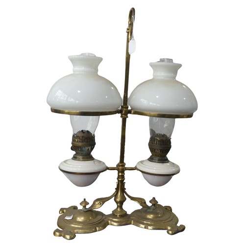 689 - A Victorian student's desk double Oil Lamp, with opaque glass shades above ceramic reservoirs, marke... 