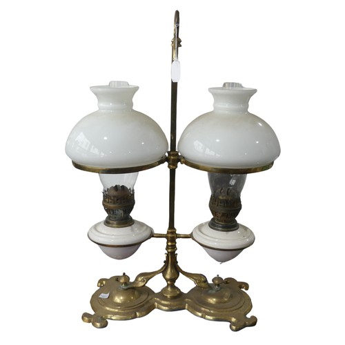 689 - A Victorian student's desk double Oil Lamp, with opaque glass shades above ceramic reservoirs, marke... 