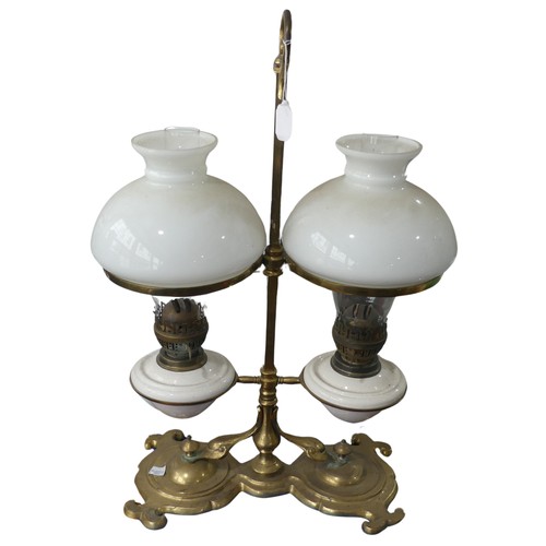 689 - A Victorian student's desk double Oil Lamp, with opaque glass shades above ceramic reservoirs, marke... 