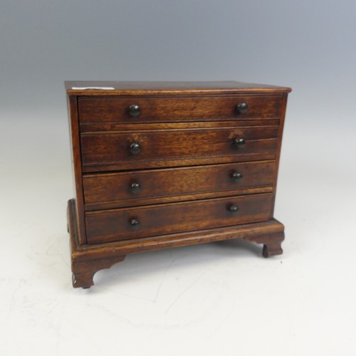 492 - An antique oak miniature tabletop Chest of drawers, rectangular top over four long graduating drawer... 