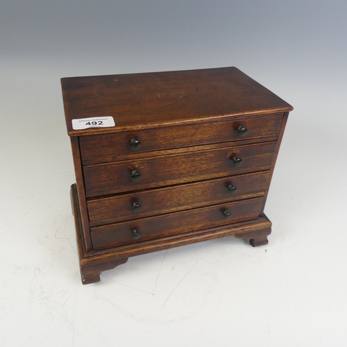 492 - An antique oak miniature tabletop Chest of drawers, rectangular top over four long graduating drawer... 